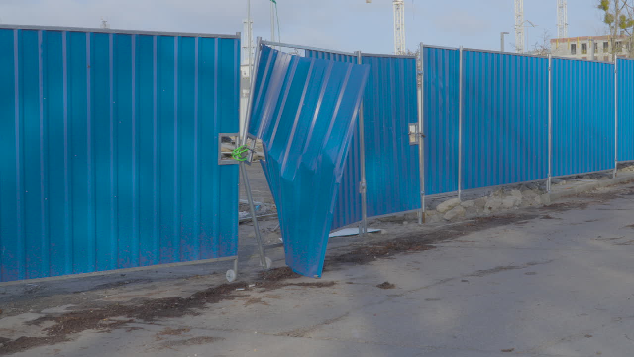 황폐화 된 파란색 판 금속 울타리