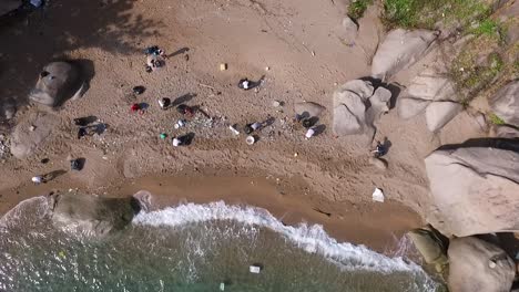 People-collecting-trash-on-beach-camera-point-down-steady-shoot-1080-HD-Asia,-Thailand-Filmed-with-Sony-AX700