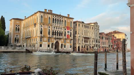 Palazzo Cavalli-Franchetti in Venice facing picturesque canal, boats passing by