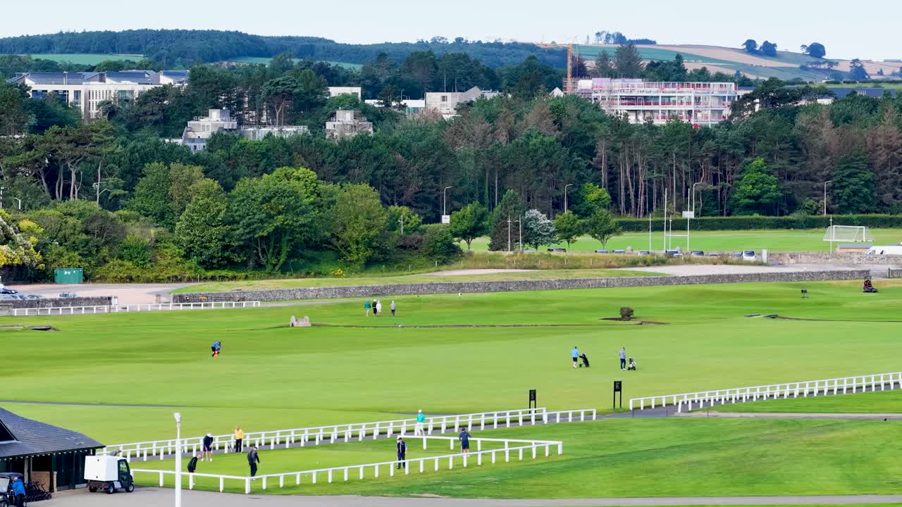 Golf Course Scene with Golfers and Green Landscape