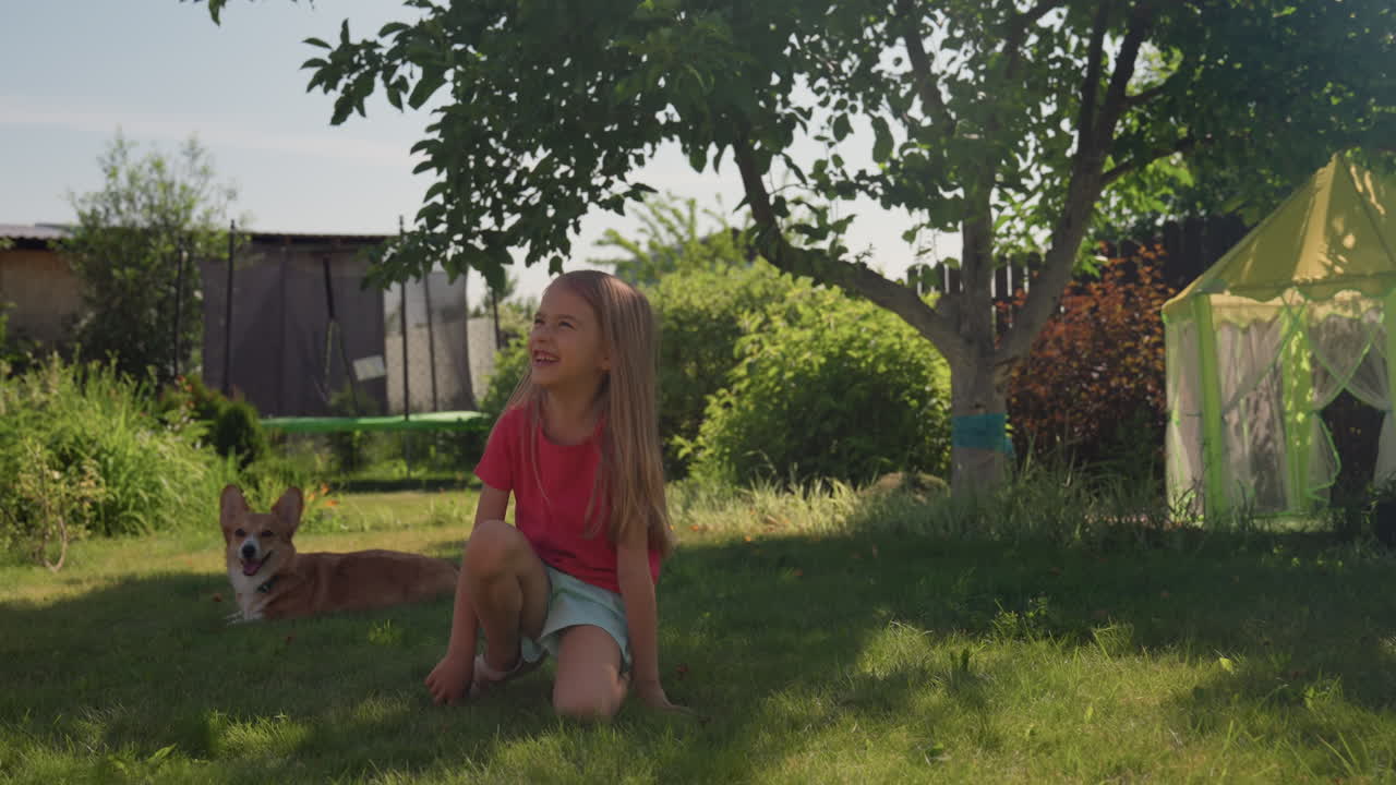 Calm Shaded Corner With Caucasian Girl Petting Corgi On Grass Under Tree, Peaceful Backyard Afternoon, Small Playhouse Nearby, Soft Sunlight Through Leaves, Gentle Child Pet Interaction And Relaxed