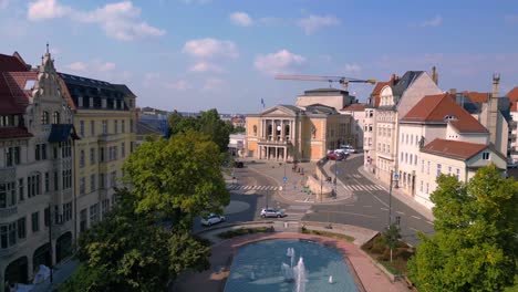 aerial view of a city square with a theater and fountain