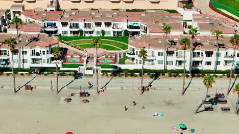 Oceanside-California-flying-left-close-up-view-of-the-beach-sand-surf-bike-path-and-hotels
