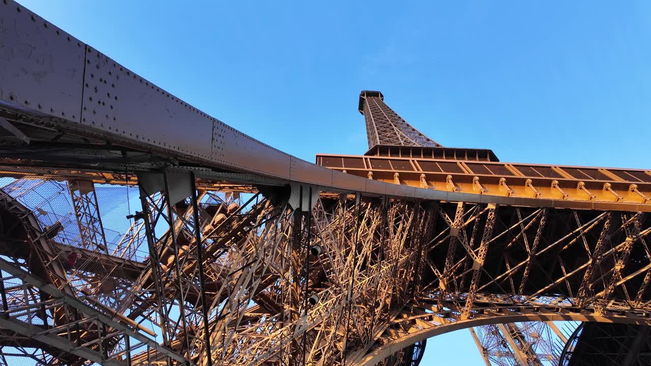 Eiffel Tower Paris France landmark puddle iron structure up-close close up, clear blue sky