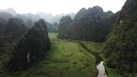 fling above a river that cuts through lush green mountainous countryside