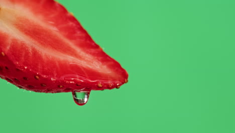 close-up of a sliced strawberry with water droplets