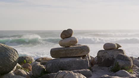 close up of a rock formations on a beach with ocean and waves