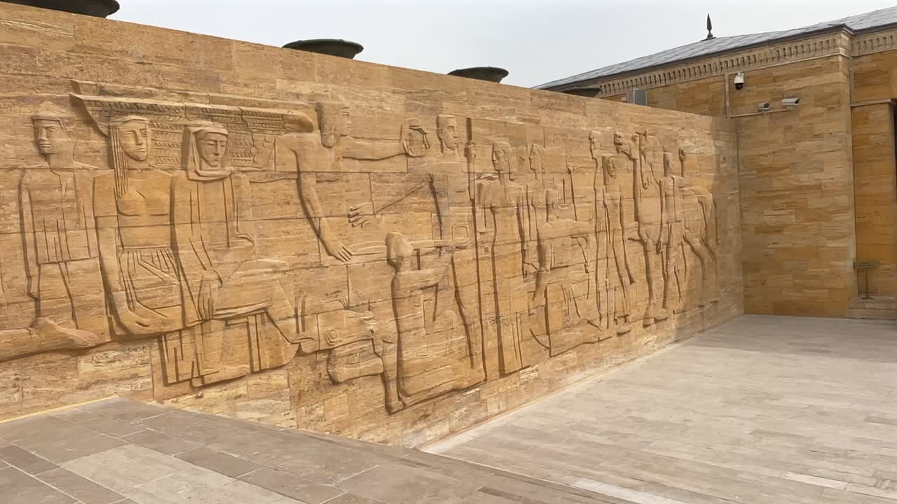 Turkey,Ankara, Ataturk's Mausoleum on a cloudy day. Camera slides slowly from right to left, lot of people walking around and climbing the stairs in front of the Monument.