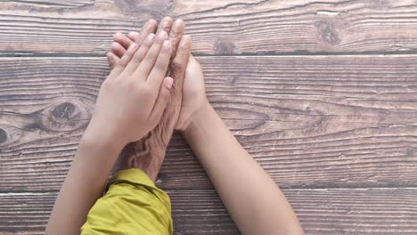 child and senior holding hands