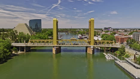 Sacramento-City-California-Aerial-v17-flyover-river-away-from-historic-yellow-ochre-tower-bridge,-panning-view-capturing-downtown-cityscape-of-the-old-town---Shot-with-Mavic-3-Cine---June-2022