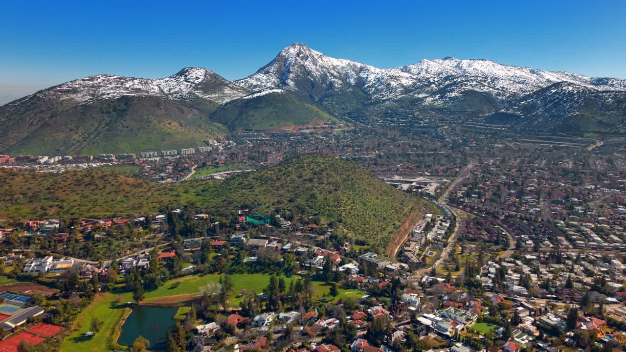 Rare snowy view of La Dehesa Golf Club, an exclusive neighborhood framed by Manquehue and Manquehuito hills
