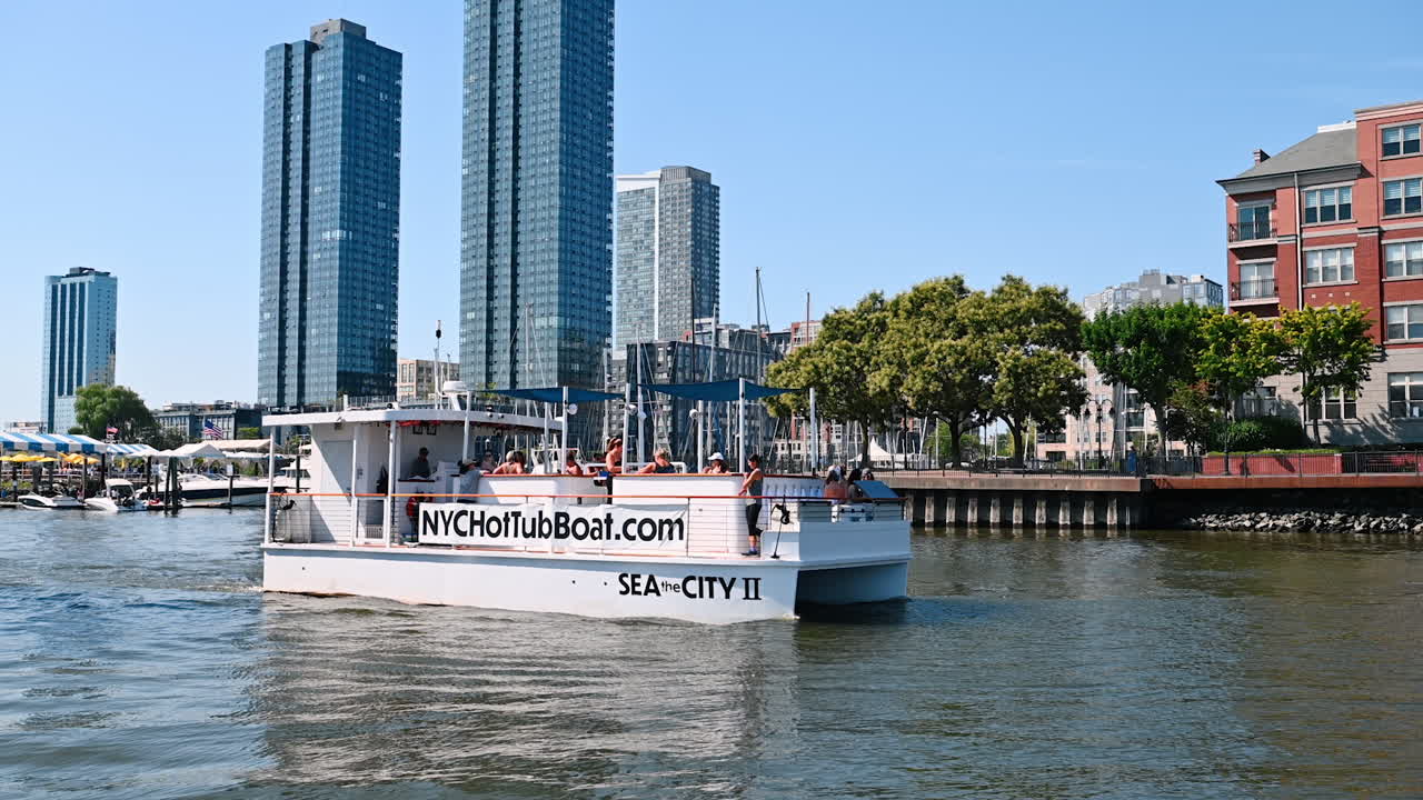 New Jersey, USA, 19 August 2025: Happy people travelling on boat on sunny summer day. River tour in Jersey City, USA