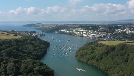 Wide-view-over-the-River-Fowey,-looking-towards-the-sea-and-the-towns-of-Polruan-and-Fowey-in-the-Cornish-area-of-outstanding-natural-beauty,-UK