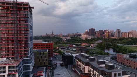 New-Residential-Building,-Crane,-Construction,-City-Skyline,-Downtown-Ottawa,-Canada,-Wide-Aerial-Establishing-Shot