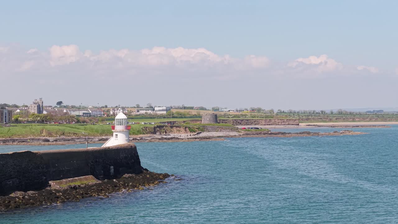 Harbor lighthouse in Balbriggan, Ireland with calm coastal scenery