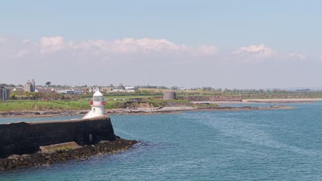 harbor lighthouse in balbriggan, ireland with calm coastal scenery