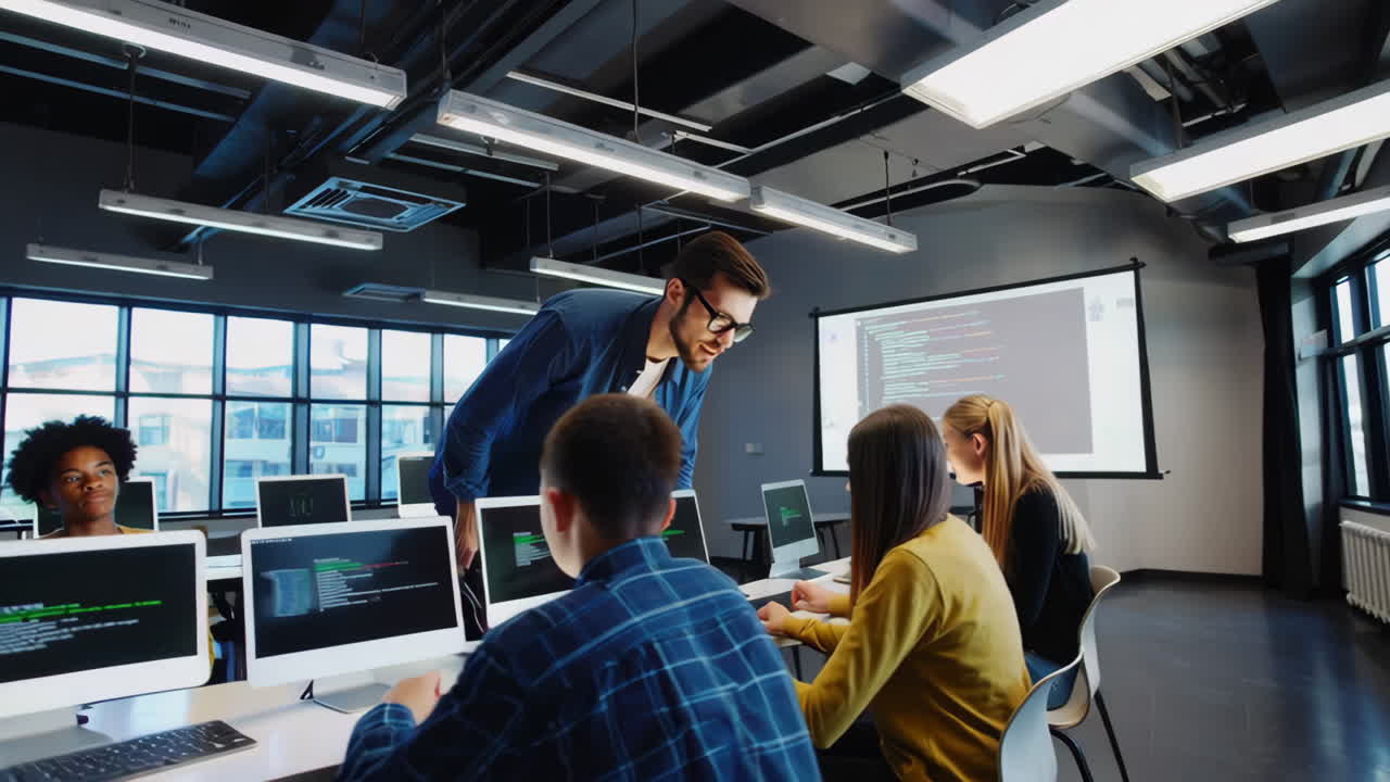 Students learning coding and programming in a modern computer lab with an instructor
