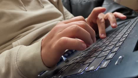 pressing backspace on laptop keyboard, closeup view of fingers and hands, correcting typing