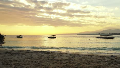 Una-Hermosa-Tarde-Con-El-Sol-Dorado-Poniéndose-Y-Brillando-En-Las-Olas-Poco-Profundas-De-Una-Isla-De-Playa-Tropical