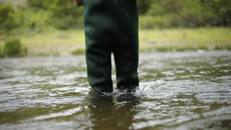 slow motion shot of a caucasian male fisherman preparing his hook while fly fishing