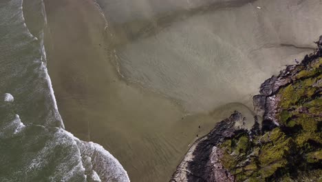 A-static-birds-eye-drone-video-looking-down-on-a-sunny-beach