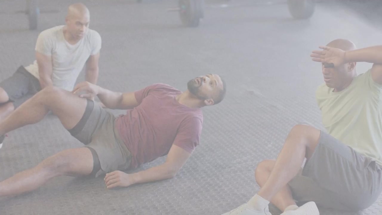 Central man shifting onto right hand, lowering back and bridging, pedaling for gym core, barbells