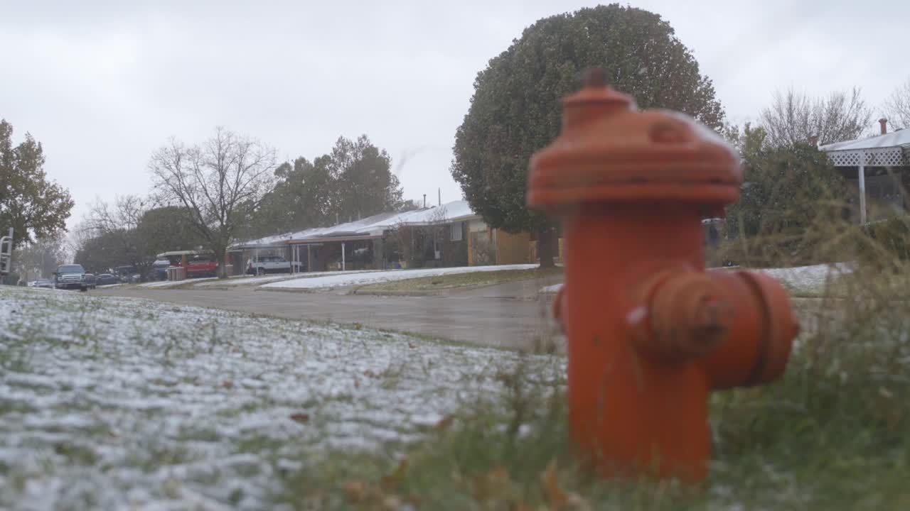 Run down neighborhood fire hydrant in the snow in slow motion