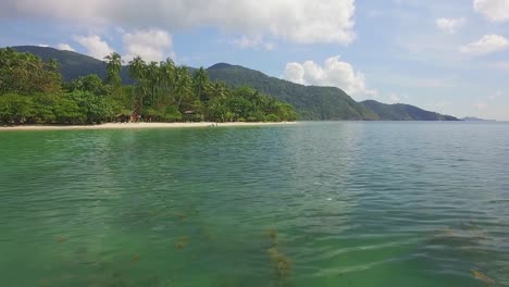 aerial dolly shot of tropical beach on koh chang with jungle and ocean and blue sky