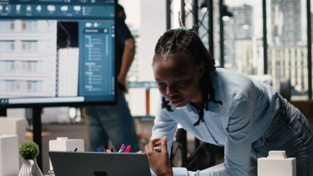 Vertical Video Real estate staff member evaluating architectural measurements on blueprints