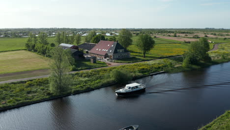 ship sailing across the canal near ossenzijl town in overijssel, friesland, netherlands