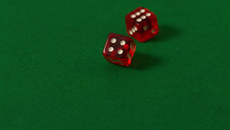 los dados rojos rodando en la mesa del casino