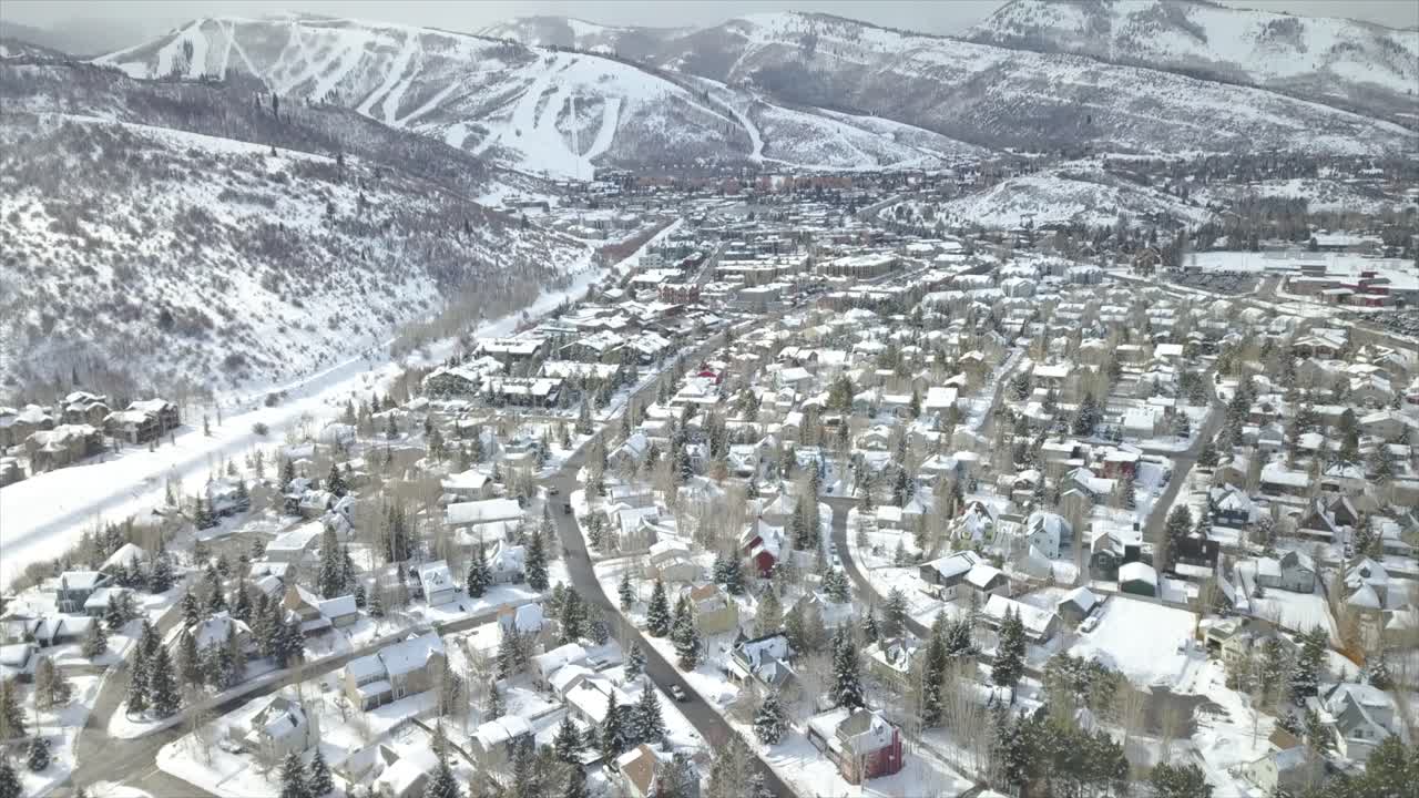 Aerial drone view high over Park City, Utah Ski Resort during Sundance Film Festival  covered by white snow during the winter season