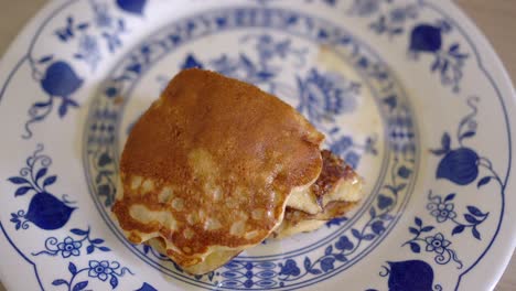 anonymous person eating tasty pancakes