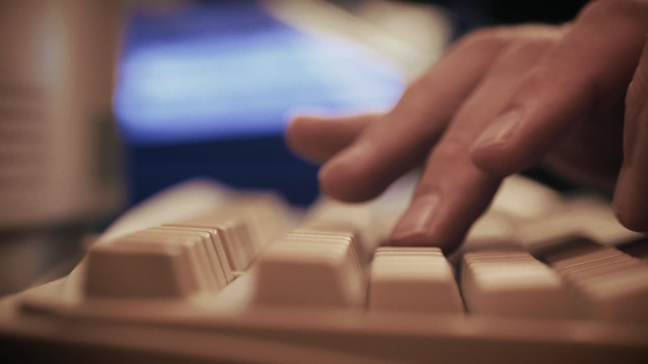 Man working and gaming on retro computer PC, IT engineer with vintage computer at home, using old fashion technology, close up of retro setup.