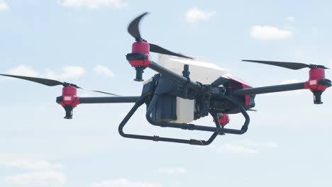 professional drone with camera flying in the blue sky