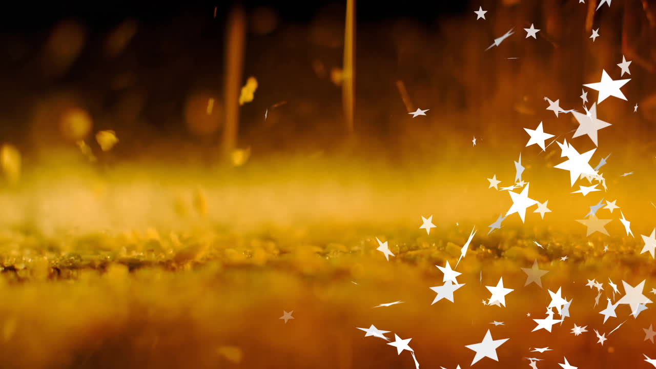 Animation of stars falling over fireworks and orange particles on dark background