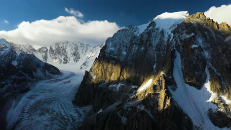 rotating revealing cinematic drone shot of a peak in the ak-sai glacier in kyrgyzstan