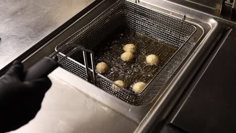 food being deep-fried in a commercial fryer