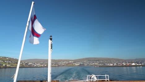 faroese flag on smyril ferry leaving torshavn city in faroe islands