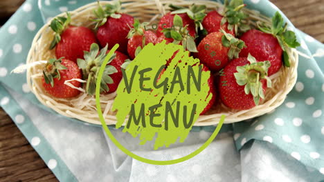 animation of vegan menu text over strawberries on table