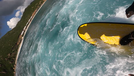 pov vertical gopro of surfer surfing on tropical ocean wave