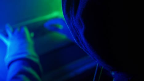 hacker using device at night