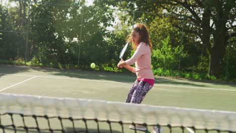 video of happy biracial woman playing tennis on the court