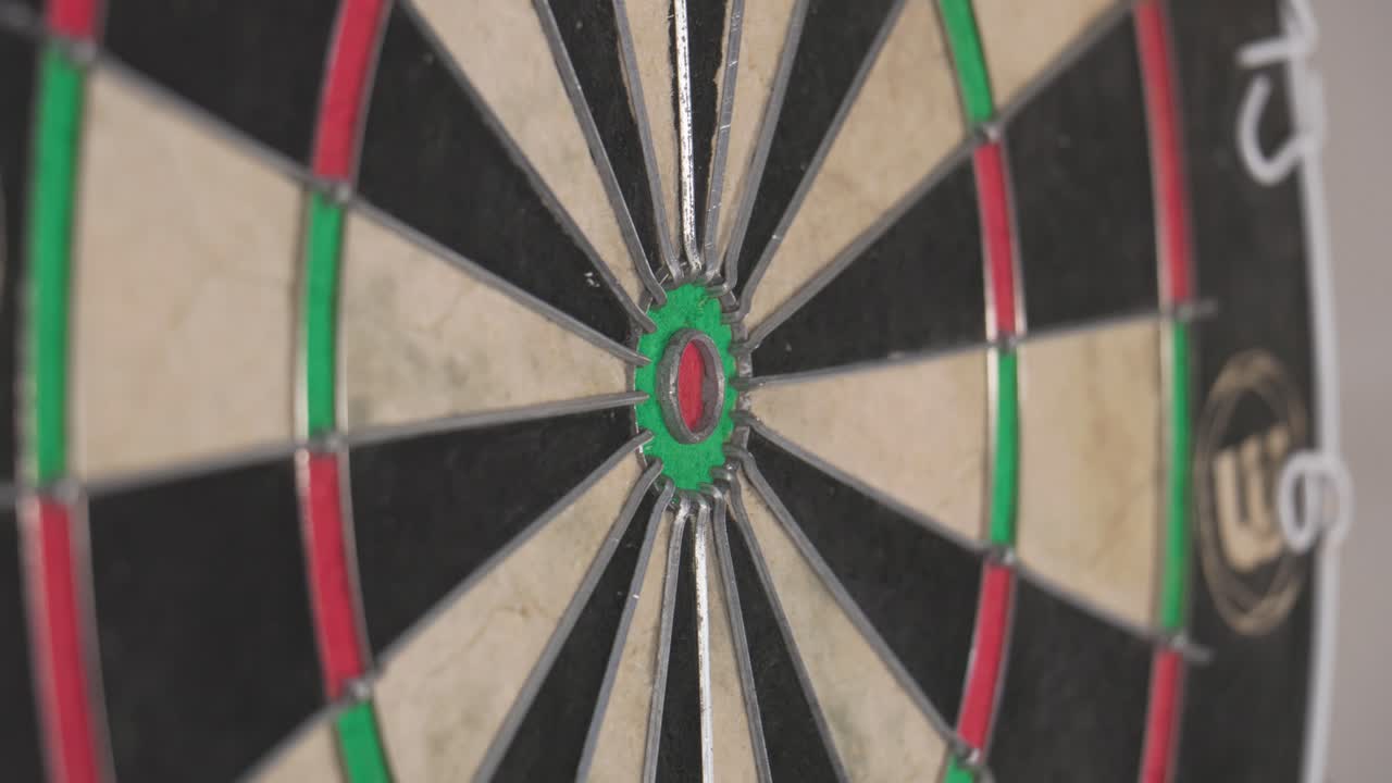 Three Darts Strike Dartboard in Close-Up Before Retrieval