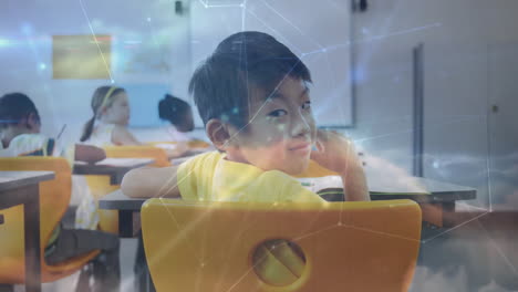 male student turning in classroom, with network overlay mapping digital education data on desks