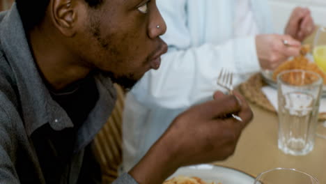 man eating lunch with friends