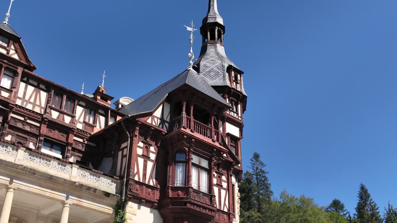 Peleș Castle in Sinaia, Romania, featuring Statuia Regelui Carol I in the foreground