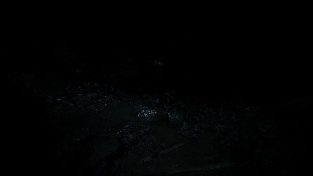 Sparkling celestial objects shine above uneven rocky landscape at night
