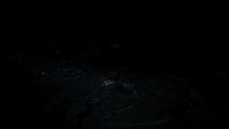 Sparkling celestial objects shine above uneven rocky landscape at night