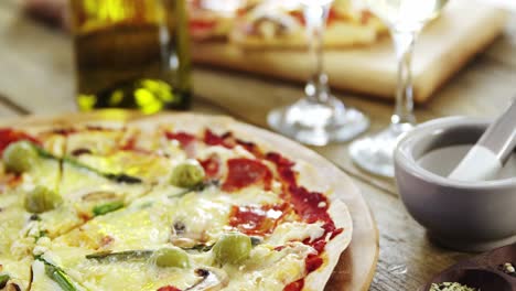 Delicious-pizza-with-a-glass-of-wine-and-spices